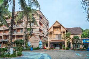 a building with a clock on the side of it at Resort Atlantis in Dhalpur