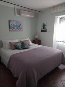 a bedroom with a large bed with two pillows on it at Casa Carini in Scansano
