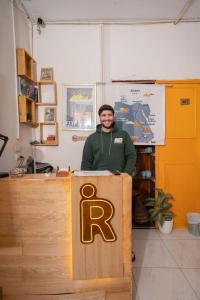 a man standing behind a podium in a room at Rhala Hostel Egypt in Cairo