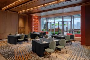 a conference room with tables and chairs and windows at Hyatt Centric The Ring Chengdu in Chengdu