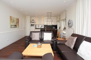 a living room with a couch and a table at Feriendorf Marienhof C2 Marieke in Borkum