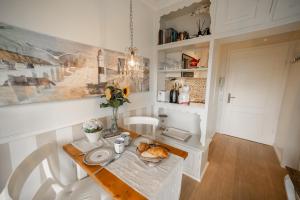 a dining room with a table and white chairs at Deichblick in List +3 photos
