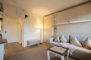 a living room with a couch and a table at Deichblick in List