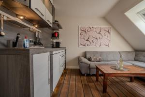 a kitchen and a living room with a couch and a table at Lister Tor 13 in List