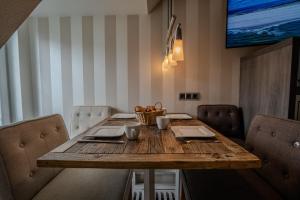 a wooden table in a dining room with chairs at Lister Tor 13 in List +8 photos