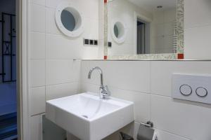 a bathroom with a white sink and a mirror at Lister Tor 13 in List