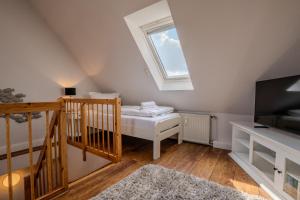 a attic room with a bed and a skylight at Lister Tor 13 in List