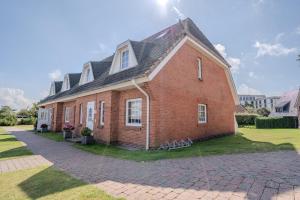 a large red brick house with a black roof at Lister Tor 13 in List