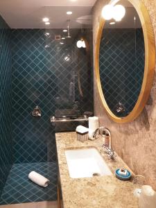 a bathroom with a sink and a mirror at Faloria Mountain Spa Resort in Cortina dʼAmpezzo