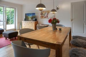 a dining room with a wooden table and chairs at Iikhoarn in List +14 photos