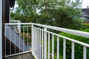 a white railing on the side of a house at Iikhoarn in List