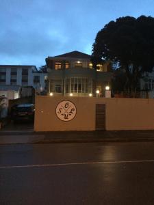 a house with a clock on the side of a wall at Soul House in Durban