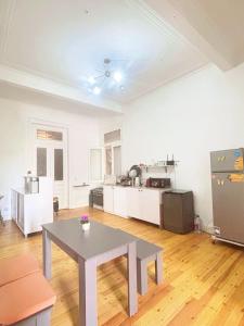 a living room with a table and a kitchen at Bisan hostel in Cairo