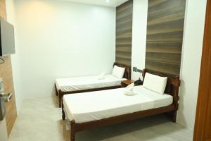 a room with two beds in a room at Lolita Heights Hotel in Tacloban +24 photos
