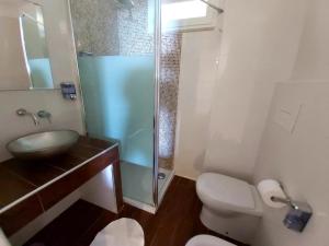 a bathroom with a shower and a toilet and a sink at Beach Club Ippocampo in Ippocampo +34 photos