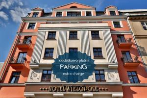 a building with a sign in front of it at Hotel Wielopole in Krakow