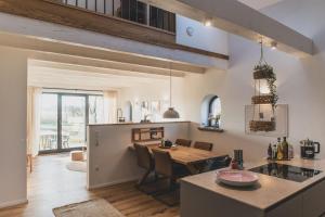 a kitchen and dining room with a table and chairs at Gulfhof Wangermeer 8 Maila in Hohenkirchen