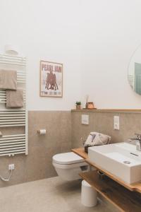 a bathroom with a toilet and a sink at Gulfhof Wangermeer 8 Maila in Hohenkirchen +61 photos