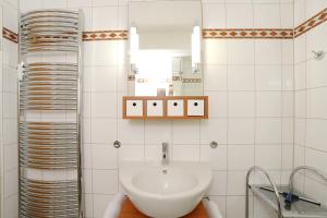a bathroom with a sink and a mirror at Strandresidenz Timmendorfer Strand Seglernest in Timmendorfer Strand +10 photos