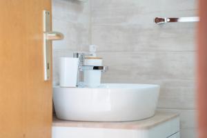 a bathroom with a white sink with towels on it at Nikola apartment in Božava