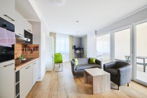a living room with a couch and a table at ADAPT APARTMENT HOTEL Wetzlar in Wetzlar