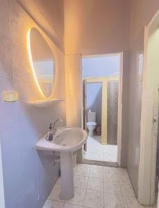 a white bathroom with a sink and a toilet at Bisan hostel in Cairo +19 photos