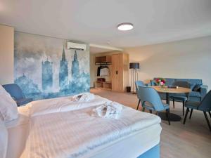 a hotel room with two beds and a table and chairs at Hostel Oschatz in Oschatz +22 photos