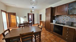 a kitchen and dining room with a table and chairs at Locanda Del Castello Bed an Breakfast in San Panfilo dʼOcre
