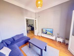a living room with a blue couch and a table at Bisan hostel in Cairo
