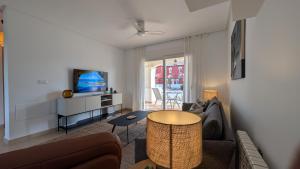 a living room with a couch and a table at Villa with private pool and BBQ on Mar Menor Golf Resort in Torre-Pacheco