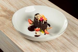 a piece of chocolate dessert in a white bowl on a table at Oak Ray Sky Terrace in Kandy