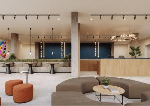 a lobby with couches and tables and a waiting room at Yugo Terrassa Can Telar in Terrassa