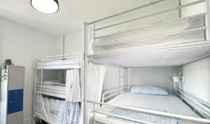 a bedroom with two bunk beds in a room at La Isleta Nest Hostel in Las Palmas de Gran Canaria