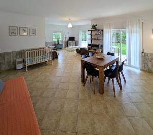 a living room with a wooden table and chairs at Apartamento Mahalo in Sagres