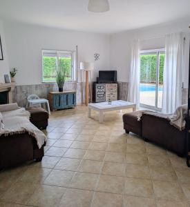 a living room with two couches and a table at Apartamento Mahalo in Sagres