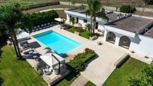 an aerial view of a house with a swimming pool at Tenuta San Nicola in Novoli