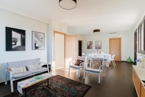 a living room with a table and chairs at Intera villa ad uso esclusivo con 2 bagni 4 camere da letto,garage,giardino,area fitness,lavatrice,wifi in Tuglie