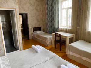 a small room with two beds and a mirror at HOTEL JULIA Akhaltsikhe in Akhaltsikhe +36 photos