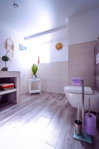 a bathroom with a tub and a sink and a toilet at Ferienwohnung Nachtweide in Wadgassen +18 photos