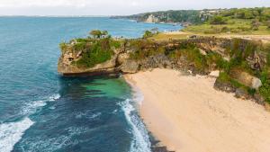 an aerial view of a beach next to the ocean at Balangan Residence in Payangan