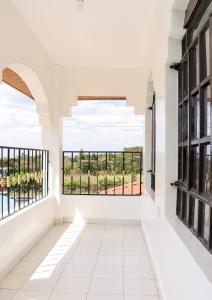 a room with white walls and windows with a view at Zaya Luxe Home in Naivasha