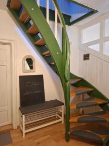 a staircase in a house with a green plant at Ferienwohnungen Schneiderhäusl inkl. Chiemgaukarte in Ruhpolding