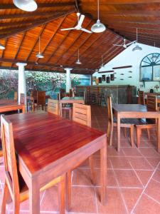 a dining room with wooden tables and chairs at The Villa Green Inn in Negombo