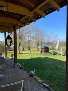 a view of a yard with a picnic table and a playground at Gite La Chouette met hottub in Beyssac