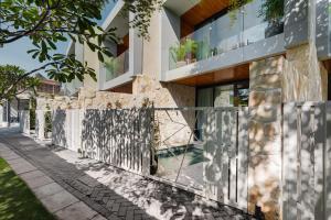 a facade of a building with a fence at Balangan Residence in Payangan +11 photos