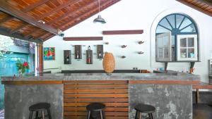 a kitchen with a bar with stools around it at The Villa Green Inn in Negombo +15 photos