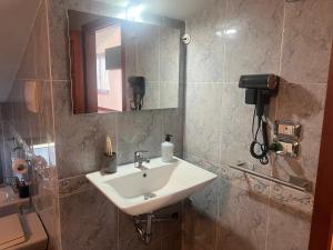a bathroom with a sink and a mirror and a toilet at B&B Menta e Rosmarino in Chiassa Superiore +84 photos