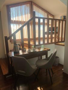 a table and chairs in a room with a balcony at B&B Menta e Rosmarino in Chiassa Superiore