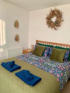 a bedroom with a bed with blue towels on it at The Nook Castle Street Ludlow in Ludlow