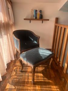 a chair sitting on the floor in a room at B&B Menta e Rosmarino in Chiassa Superiore